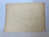 an old piece of paper sitting on top of a white table