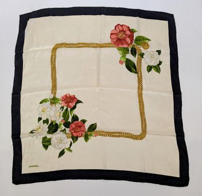 a close up of a white and black square with flowers on it