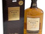 une bouteille de whisky William Peel à côté d'une boîte