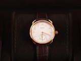 an image of a watch sitting in a box on a black surface
