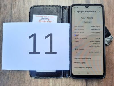 an image of a cell phone sitting on top of a table next to a paper