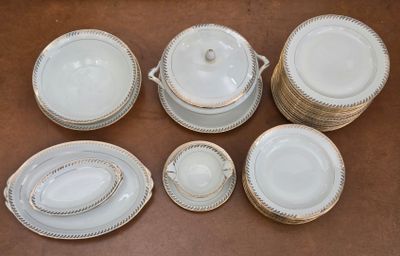 an image of a group of white dishes and cups on a table