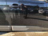 a police officer that is standing in front of a car