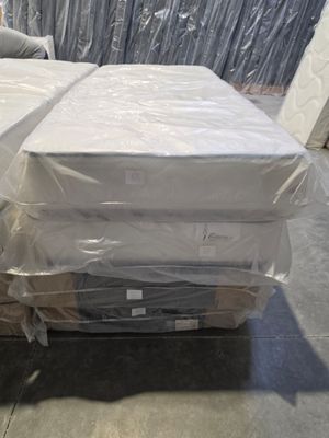 boxes of mattresses are stacked on top of each other in a warehouse