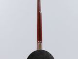 a close up of a guitar hanging from a string on a white background