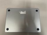 the back of a silver laptop computer sitting on top of a table