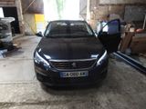 a black car parked in a garage with a door open