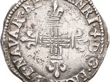 an old silver coin with a cross on it