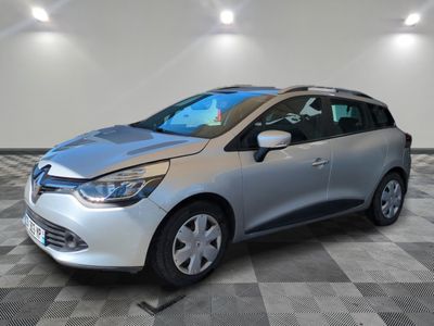 a silver car is parked in a room with a checkered floor