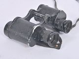 two binoculars that are sitting on a white surface
