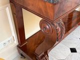 a marble counter top on a wooden table in a room
