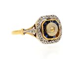 a close up of a gold and blue stone ring on a white background