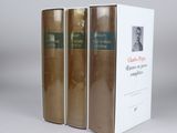 three books sitting on top of a white box on a table