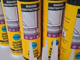 several tubes of glue are lined up on a table