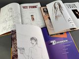 a lot of books that are open on a table