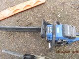 two chainsaws that are laying on the ground