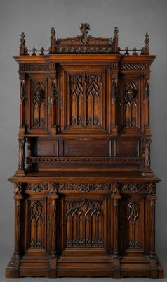 an old wooden cabinet with ornate carvings on the top
