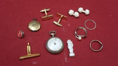 many different types of jewelry on a red surface