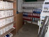a room with a lot of boxes on the shelves