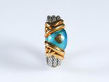 a close up of a ring with a blue stone on it