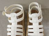 white leather sandals with straps and buckles on the toes