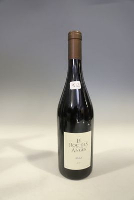 the bottle of red wine is sitting on the table