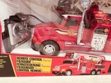 toy fire truck in a box on a table with a remote control