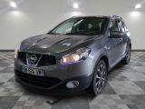 the front of a silver nissan rav parked on a checkered floor