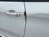 a close up of a car door handle with a hole in it