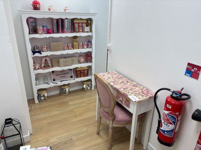 a desk with a chair and a fire extinguisher in the corner