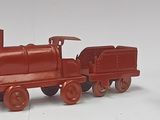 three toy trains sitting next to each other on a white surface