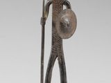 statue of a man holding a shield and a shield with a hat on his head