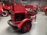 a red fire truck that is parked in a garage