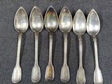 six spoons are lined up in a row on a table