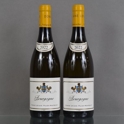 two bottles of wine sitting on top of a table next to each other