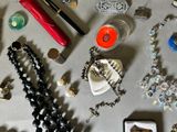 a lot of jewelry on a table with a red lipstick