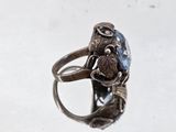 an image of a ring with a blue stone in it