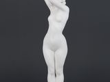 a white statue of a woman standing on a pedestal