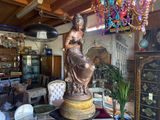 a statue of a woman sitting on a pedestal in a room