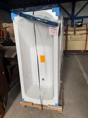 une baignoire blanche posée sur une palette dans un entrepôt