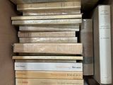 a box full of books that are stacked on top of each other