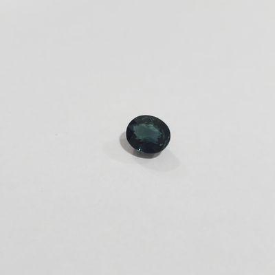 a close up of a black diamond on a white surface