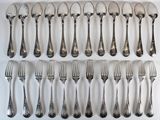 many forks and spoons laid out on a white surface