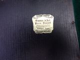 a plaque on the back of a black suitcase