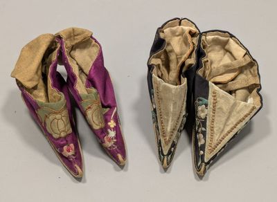 two pairs of chinese shoes are shown on a white surface