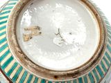a close up of a vase with a clock on it