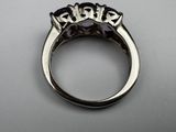 a close up of a ring with three stones in it