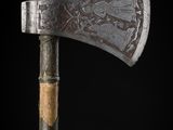 an old axe with a wooden handle on a black background
