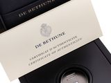 a close up of a box with a coin inside of it