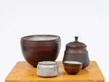 three bowls and a bowl on a small wooden table